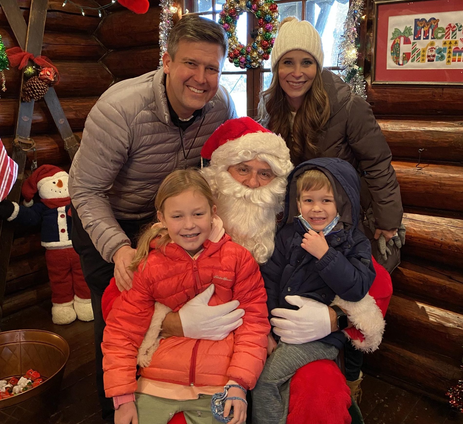 Emily Raguse and Lou Raguse and kids sitting on Santa's lap